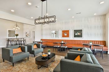 A living room with couches and chairs and a dining room with tables
